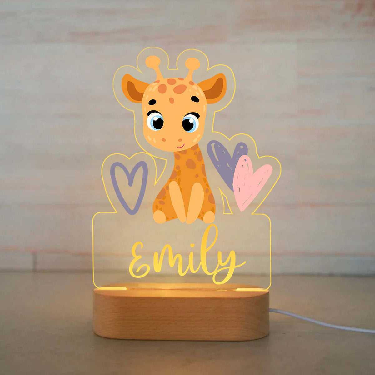 Acrylic giraffe night light on a wooden base